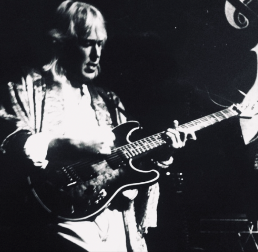 Black and white photo of Ian Edwards playing guitar